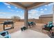 Covered patio with seating area, grill, and spacious backyard at 4887 N 179Th Dr, Goodyear, AZ 85395