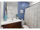 Bathroom with blue walls, white vanity, and floral shower curtain at 4887 N 179Th Dr, Goodyear, AZ 85395