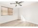 Bedroom with wood-look flooring, window blinds and ceiling fan at 531 W Spur Ave, Gilbert, AZ 85233