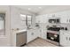 Modern kitchen with white cabinets, stainless steel appliances, and quartz countertops at 531 W Spur Ave, Gilbert, AZ 85233