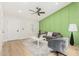 Light and airy living room with a green accent wall and modern furniture at 531 W Spur Ave, Gilbert, AZ 85233