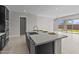 Modern kitchen features stainless steel appliances, black cabinets and an island with a sink and countertop seating at 5525 N 193Rd Dr, Litchfield Park, AZ 85340