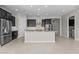 Contemporary kitchen featuring stainless steel appliances, a large island with a sink, and ample cabinet space at 5525 N 193Rd Dr, Litchfield Park, AZ 85340