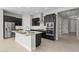 Well-equipped kitchen with stainless steel appliances, dark cabinets, and a central island for food preparation and serving at 5525 N 193Rd Dr, Litchfield Park, AZ 85340