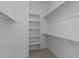 Organized walk-in closet with multiple shelves and rods, offering ample storage space for clothing and accessories at 5525 N 193Rd Dr, Litchfield Park, AZ 85340