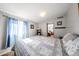 Comfortable bedroom with a queen bed and access to another room at 5543 W Gardenia Ave, Glendale, AZ 85301