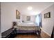 Spacious bedroom with a large bed and tile floors at 5543 W Gardenia Ave, Glendale, AZ 85301