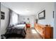 Small bedroom with a twin bed and dresser at 5543 W Gardenia Ave, Glendale, AZ 85301