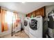 Bright laundry room with washer, dryer, and storage at 5543 W Gardenia Ave, Glendale, AZ 85301