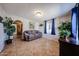 Living room with a brown couch and tile floors at 5543 W Gardenia Ave, Glendale, AZ 85301