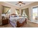 Bedroom with wood furniture, neutral bedding, and patio access at 6202 E Mckellips Rd # 42, Mesa, AZ 85215
