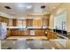 Spacious community kitchen with wood cabinets and granite counters at 6202 E Mckellips Rd # 42, Mesa, AZ 85215
