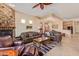 Open living area with a stone fireplace and leather furniture at 6202 E Mckellips Rd # 42, Mesa, AZ 85215