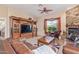 Living room features a stone fireplace and an entertainment center at 6202 E Mckellips Rd # 42, Mesa, AZ 85215