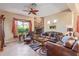 Living room with stone fireplace, leather furniture, and a ceiling fan at 6202 E Mckellips Rd # 42, Mesa, AZ 85215