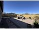 Spacious backyard featuring a covered patio, brick pavers, and comfortable outdoor seating at 6516 W Madre Del Oro Dr, Phoenix, AZ 85083