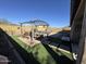 An inviting backyard with a pergola, artificial turf, and a well-maintained patio at 6516 W Madre Del Oro Dr, Phoenix, AZ 85083