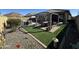 Backyard featuring artificial turf, patio area, and comfortable outdoor seating at 6516 W Madre Del Oro Dr, Phoenix, AZ 85083