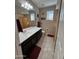 Well-lit bathroom featuring a dark vanity, neutral tile floors, and decorative fish accents at 6516 W Madre Del Oro Dr, Phoenix, AZ 85083