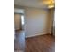 Bright bedroom featuring wood floors, neutral walls, and views into the next room at 6516 W Madre Del Oro Dr, Phoenix, AZ 85083