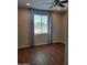 Cozy bedroom showcasing wood floors, large window with mountain views, and elegant curtains at 6516 W Madre Del Oro Dr, Phoenix, AZ 85083