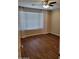 Bedroom with wood flooring, a window with blinds, and neutral colored walls at 6516 W Madre Del Oro Dr, Phoenix, AZ 85083