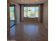 Bright dining area with a large window, sliding glass door, and tile flooring at 6516 W Madre Del Oro Dr, Phoenix, AZ 85083