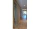 View of the home's hallway with tile flooring leading to the kitchen and living area at 6516 W Madre Del Oro Dr, Phoenix, AZ 85083