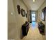 Elegant hallway with tile floors, neutral walls, and decorative mirrors and artwork at 6516 W Madre Del Oro Dr, Phoenix, AZ 85083