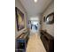 Stylish hallway featuring neutral paint, tile flooring, wooden furniture, and decorative wall art at 6516 W Madre Del Oro Dr, Phoenix, AZ 85083