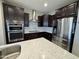 Modern kitchen with stainless steel appliances, mosaic tile backsplash, and quartz countertops at 6516 W Madre Del Oro Dr, Phoenix, AZ 85083