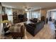 Spacious living room with comfortable seating, a ceiling fan, tile floors, and large windows at 6516 W Madre Del Oro Dr, Phoenix, AZ 85083