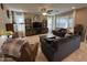 Spacious living room with comfortable seating, a ceiling fan, tile floors, and large windows at 6516 W Madre Del Oro Dr, Phoenix, AZ 85083