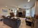 Spacious living room with comfortable seating, a ceiling fan, tile floors, and large windows at 6516 W Madre Del Oro Dr, Phoenix, AZ 85083