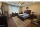 Main bedroom with wood flooring, a large window, and an area rug at 6516 W Madre Del Oro Dr, Phoenix, AZ 85083