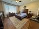 Main bedroom with wood flooring, a large window, and an area rug at 6516 W Madre Del Oro Dr, Phoenix, AZ 85083