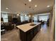 Open floorplan with spacious kitchen with an island and dining area, and large living room space at 6516 W Madre Del Oro Dr, Phoenix, AZ 85083