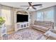 Living room with gray sofas, a large TV stand, and decorative rug at 8072 W Georgetown Way, Florence, AZ 85132