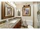 Bathroom features granite counters, wood cabinets, framed mirror, and glass shower at 8631 E Vista Dr, Scottsdale, AZ 85250