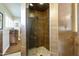 Close-up of a modern shower featuring stylish tile, a glass door, and sleek fixtures at 8631 E Vista Dr, Scottsdale, AZ 85250