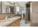 Stylish bathroom featuring a granite vanity, a shower with glass enclosure, and elegant decor at 8631 E Vista Dr, Scottsdale, AZ 85250