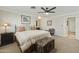 Serene bedroom with an ornate bedside table, a ceiling fan, and soft, neutral decor at 8631 E Vista Dr, Scottsdale, AZ 85250