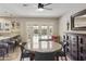 A dining area with French doors leading to the pool, complete with a ceiling fan and ornate buffet table at 8631 E Vista Dr, Scottsdale, AZ 85250