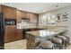 Updated kitchen with stainless steel appliances, stone counter seating, and stylish wooden cabinets at 8631 E Vista Dr, Scottsdale, AZ 85250