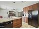 Modern kitchen with stainless steel appliances, granite countertops, and custom cabinetry at 8631 E Vista Dr, Scottsdale, AZ 85250