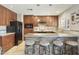 Updated kitchen featuring a breakfast bar with stone accents and rich wood cabinetry at 8631 E Vista Dr, Scottsdale, AZ 85250