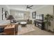 Cozy living room featuring a ceiling fan, plush seating, and a bright window with shutters at 8631 E Vista Dr, Scottsdale, AZ 85250