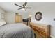 Spacious main bedroom featuring a ceiling fan, dresser and an ensuite bathroom at 8631 E Vista Dr, Scottsdale, AZ 85250