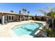 Backyard pool with travertine decking, patio space, and desert landscaping at 8631 E Vista Dr, Scottsdale, AZ 85250