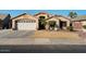 House exterior featuring a large garage and well-maintained lawn at 9628 E Olla Ave, Mesa, AZ 85212
